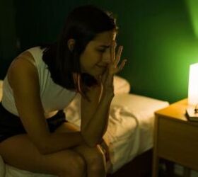 how to stop your dog from barking during the night, Woman awake at night image via Canva